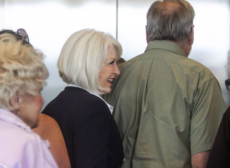 Former Mesa County, Colo., Tina Peters, center, laughs as she waits with her supporters for an elevator at the Mesa County Justice Center Monday, Aug. 12, 2024, in Grand Junction, Colo. (Larry Robinson/Grand Junction Sentinel via AP)