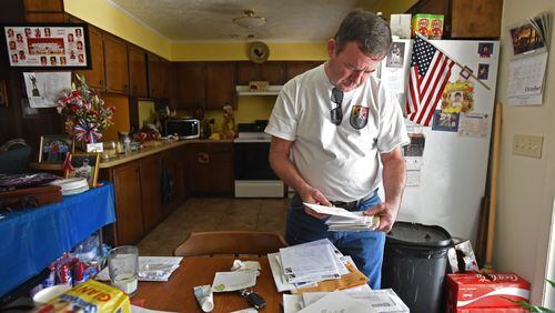 Ardie Wright glances at a stack of sympathy cards. He hasn’t had time to open them yet. People from across the country – neighbors, friends, even strangers – are writing to offer their condolences about the death of his son, Staff Sgt. Dustin Wright. “He was like John Wayne, OK?” Ardie said of his son. “When he walked through the door with his sparkling blue eyes – and his smile – he just lit the room up." HYOSUB SHIN / HSHIN@AJC.COM