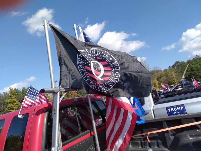 A QAnon flag flies from a truck in a pro-Trump caravan in metro Atlanta Nov. 1, 2020.