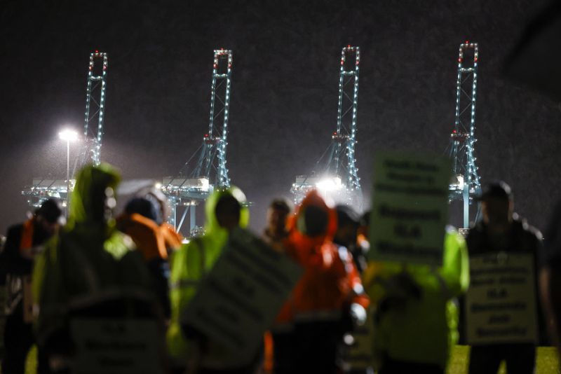 Hundreds of longshoremen strike together outside of the Virginia International Gateway in Portsmouth, Va., Tuesday, Oct. 1, 2024. (Billy Schuerman/The Virginian-Pilot via AP)