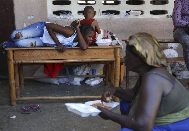 People displaced by armed gang attacks rest at the Antoinette Dessalines National School, a makeshift shelter, in Saint-Marc, Haiti, Sunday, Oct. 6, 2024. (AP Photo/Odelyn Joseph)