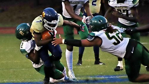 Southwest DeKalb's Tamir Rudolph gains yardage against the Clarkston defense on Sept 5, 2024.