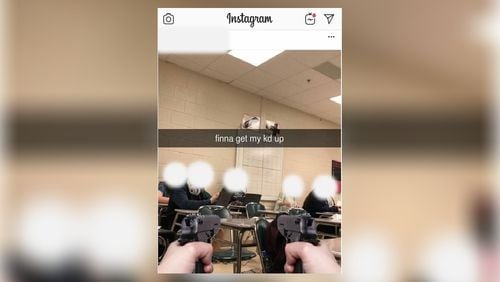 A Pickens High School student was arrested Thursday morning after posting a photo online that appears to show two guns pointed at five students seated in a classroom.