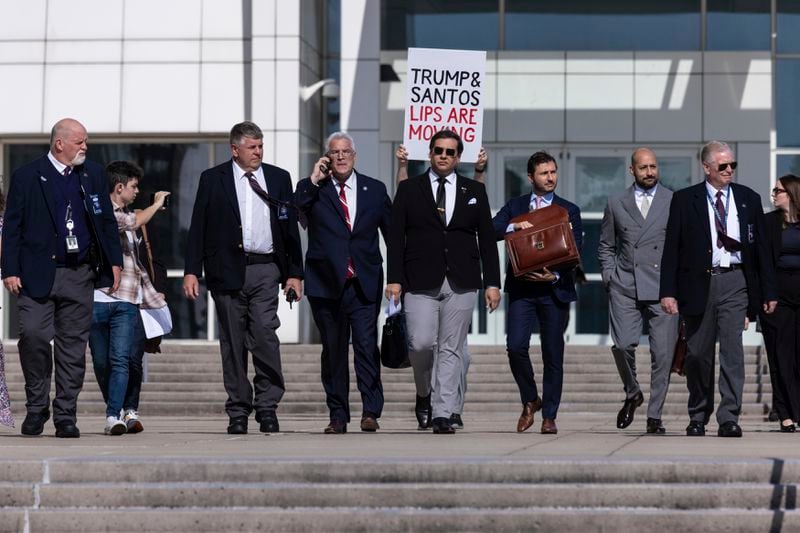 Former U.S. Rep George Santos leaves the federal courthouse with his lawyers in Central Islip, N.Y. on, Monday, Aug., 19, 2024 in New York. (AP Photo/Stefan Jeremiah)