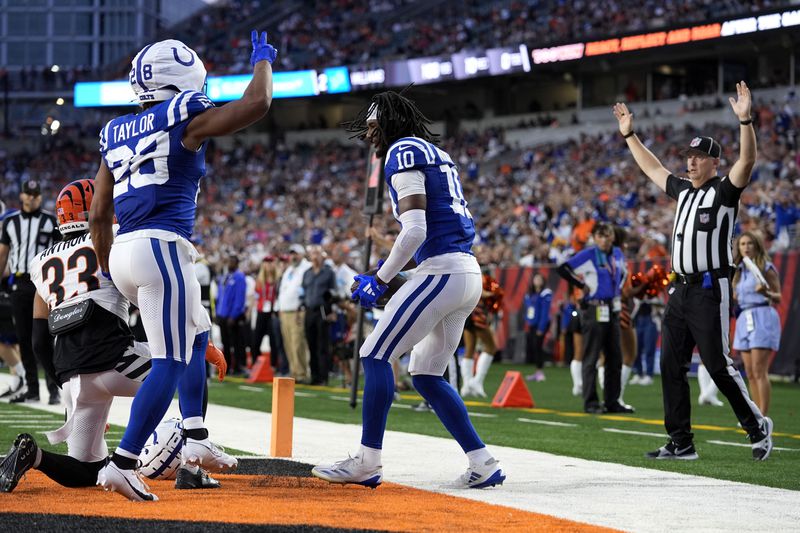 Indianapolis Colts wide receiver Adonai Mitchell (10) celebrates with teammate running back Jonathan Taylor (28) after catching a 9-yard touchdown pass in the first half of a preseason NFL football game against the Cincinnati Bengals, Thursday, Aug. 22, 2024, in Cincinnati. (AP Photo/Carolyn Kaster)