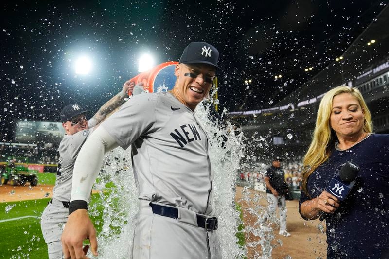 New York Yankees' Aaron Judge is doused by his teammates after he hit his 300th career home run, the fastest player to do so in MLB history, in a baseball game against the Chicago White Sox, Wednesday, Aug. 14, 2024, in Chicago. (AP Photo/Erin Hooley)