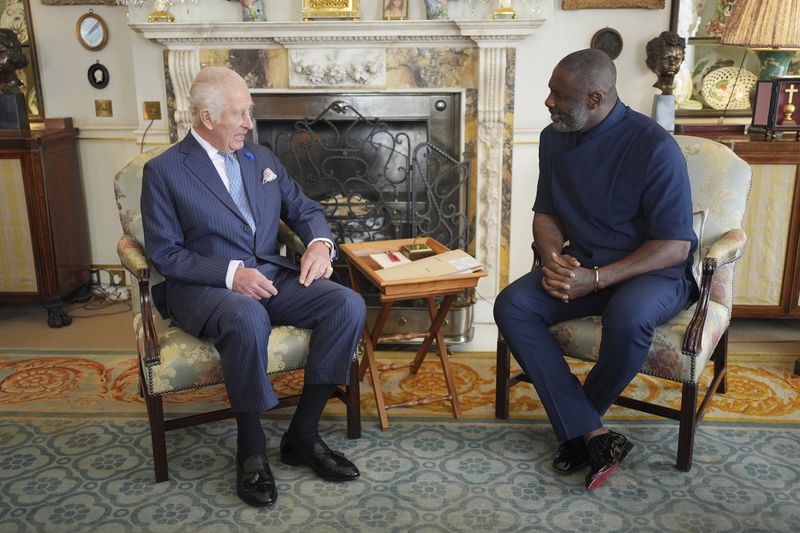 King Charles III with Idris Elba, attend an event for The King's Trust to discuss youth opportunity, at St James's Palace in central London, Friday July 12, 2024. The King and Mr Elba, an alumnus of The King's Trust (formerly known as The Prince's Trust), are meeting about the charity's ongoing work to support young people, and creating positive opportunities and initiatives which might help address youth violence in the UK, as well as the collaboration in Sierra Leone between the Prince's Trust International and the Elba Hope Foundation. (Yui Mok/pool photo via AP)