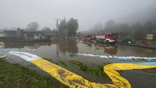 This handout photo provided by the Polish fire department, shows firefighters pump water and mud from city streets and help clean the city of Głogow that was hit by a high flood wave, in Głogow, southwestern Poland, on Wednesday, Sept. 18, 2024. (KG PSP via AP)