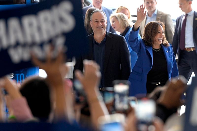 Democratic presidential nominee Vice President Kamala Harris, right, and second gentleman Doug Emhoff greet supporters upon arriving at Pittsburgh International Airport, Sunday, Aug. 18, 2024, in Pittsburgh. (AP Photo/Julia Nikhinson)