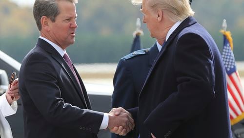 FILE - Georgia Gov. Brian Kemp, left, greets President Donald Trump as he arrives at Dobbins Air Reserve Base, Nov. 8, 2019, in Marietta, Ga. (Curtis Compton/Atlanta Journal-Constitution via AP, File)