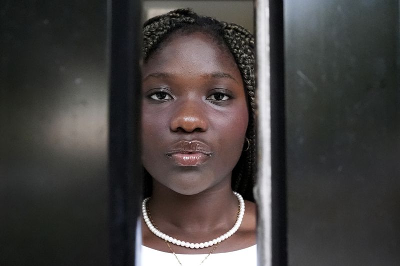 Adjovi Golo looks out from a dormitory at DePaul University in Chicago, Wednesday, Aug. 28, 2024. (AP Photo/Nam Y. Huh)