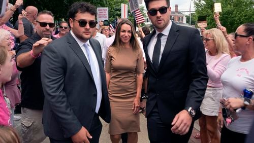 Karen Read, center, is flanked by security as she arrives at Norfolk Superior Court for a hearing, Monday, July 22, 2024, in Dedham, Mass. (AP Photo/Charles Krupa)