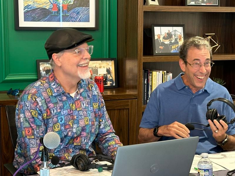 WSB host Eric Von Haessler and former host Clark Howard have a laugh during a commercial break near the end of the annual WSB Care-a-thon for Aflac Cancer and Blood Disorders Center. This year, they raised more than $2 million for the first time ever. RODNEY HO/rho@ajc.com