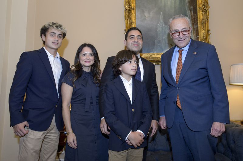 Senator-designee George Helmy, D-N.J., second from right, poses with his wife Caroline Helmy, second from left, and his sons Joshua, 15, left, and Elijah, 12, third from left, and Senate Majority Leader Chuck Schumer, D-N.Y., right, prior to taking the oath of office in the Old Senate Chamber at the Capitol in Washington, Monday, Sept. 9, 2024. (AP Photo/Rod Lamkey, Jr.)