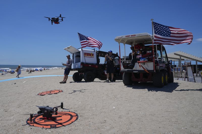 A drone prepares to land for a battery swap at Rockaway Beach in New York, Thursday, July 11, 2024. A fleet of drones patrolling New York City’s beaches for signs of sharks and struggling swimmers is drawing backlash from an aggressive group of seaside residents: local shorebirds. Since the drones began flying in May, flocks of birds have repeatedly swarmed the devices, forcing the police department and other city agencies to adjust their flight plans. (AP Photo/Seth Wenig)