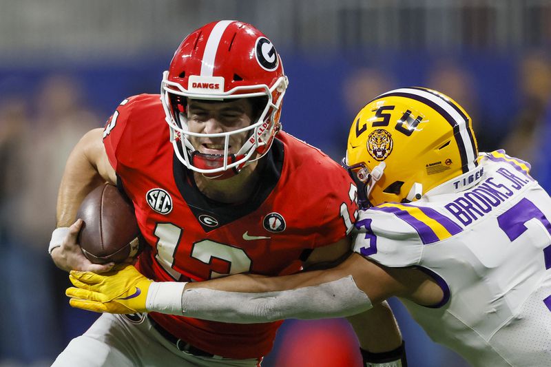 Georgia Bulldogs quarterback Stetson Bennett (13) runs against the LSU Tigers during the second half of the the SEC Championship game at Mercedes-Benz Stadium, Saturday, December 3, 2022, in Atlanta. (Jason Getz / Jason.Getz@ajc.com)
