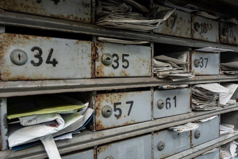 Letterboxes stuffed with mails are seen at the Cha Kwo Ling village in east Kowloon, Hong Kong, Sunday, Aug. 25, 2024. (AP Photo/Chan Long Hei)