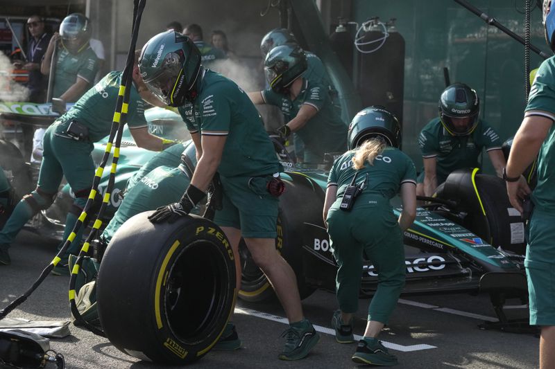 Technicians work on the car of Aston Martin driver Lance Stroll of Canada in the team garage at the Baku circuit, in Baku, Azerbaijan, Thursday, Sept.12, 2024. (AP Photo/Sergei Grits)