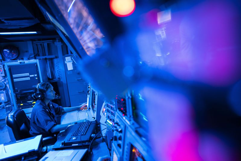 FILE -Crew members work in the combat information center of the Arleigh Burke-class guided missile destroyer USS Laboon during a deployment in the Red Sea, June 12, 2024. (AP Photo/Bernat Armangue, File)