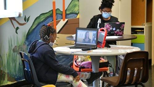 Meah Pettaway-Johnson, foreground, 7, works on her laptop for her school online class at Girls Inc. in Marietta on Wednesday, August 19, 2020. Girls Inc. has opened its center during school hours to provide support to girls in kindergarten through eighth grade as they complete their online school work. (Hyosub Shin / Hyosub.Shin@ajc.com)