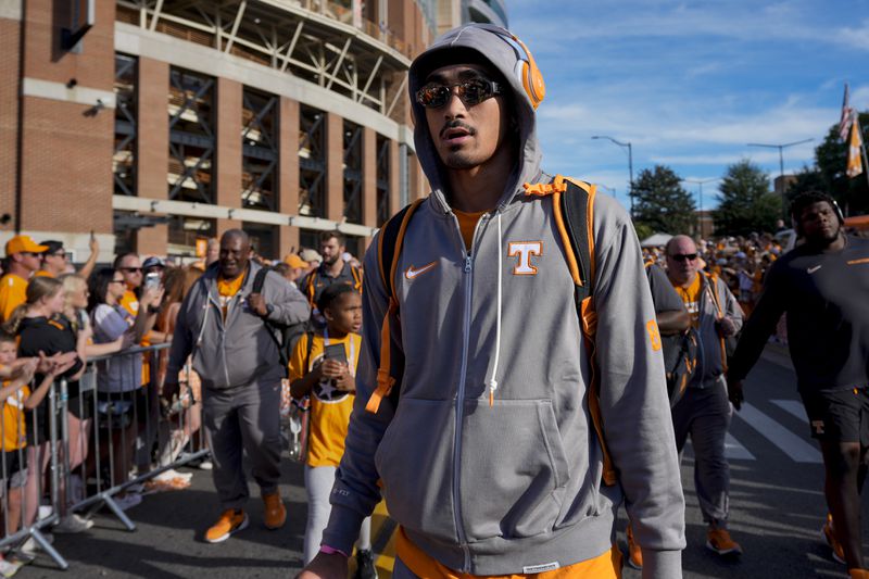 Tennessee quarterback Nico Iamaleava walks with the team into Neyland Stadium before an NCAA college football game against Kent State, Saturday, Sept. 14, 2024, in Knoxville, Tenn. (AP Photo/George Walker IV)