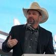 FILE - Garth Brooks speaks during a groundbreaking ceremony for the Tennessee Titans new NFL football stadium, Feb. 29, 2024, in Nashville, Tenn. (AP Photo/George Walker IV, File)