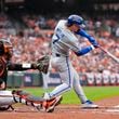 Kansas City Royals' Bobby Witt Jr. (7) hits a single as home plate umpire Ben May, left, and Baltimore Orioles catcher Adley Rutschman look on during the third inning in Game 2 of an AL Wild Card Series baseball game, Wednesday, Oct. 2, 2024 in Baltimore. (AP Photo/Stephanie Scarbrough)