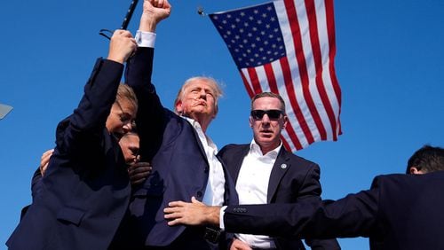  Donald Trump, surrounded by Secret Service, after a shooting happened at a campaign rally. AP Photo/Evan Vucci 