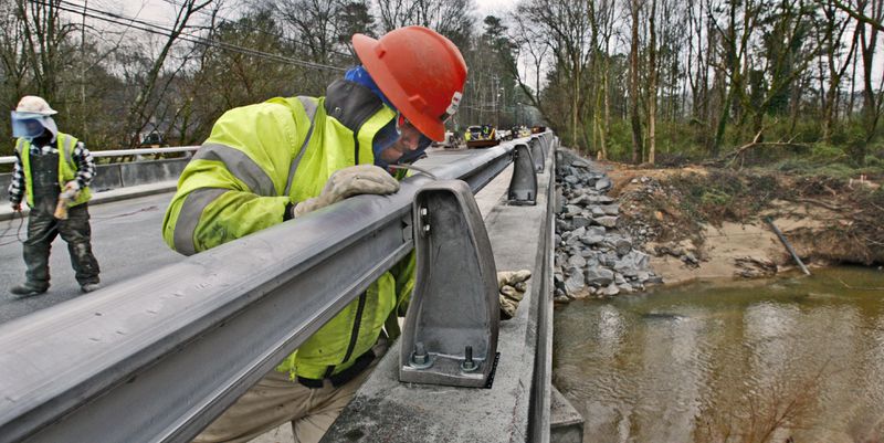 A construction worker works on the Peachtree Dunwoody bridge over Nancy Creek on March 23, 2010. John Spink, jspink@ajc.com