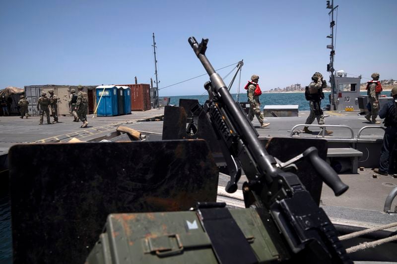 FILE - U.S. Army soldiers stand at the U.S.-built floating pier Trident backdropped by the coast of the Gaza Strip, June 25, 2024. (AP Photo/Leo Correa, File)