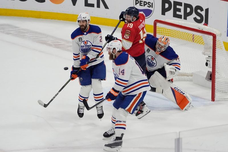 Edmonton Oilers defenseman Evan Bouchard (2) stops a shot on goal during the third period of Game 5 of the NHL hockey Stanley Cup Finals against the Florida Panthers, Tuesday, June 18, 2024, in Sunrise, Fla. (AP Photo/Rebecca Blackwell)