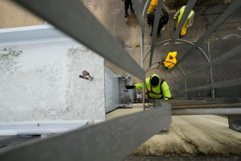 Delwyn Bodden, a worker for the Southeast Louisiana Flood Protection Authority-West climbs a ladder up a floodgate to lock it closed along the Harvey Canal, just outside the New Orleans city limits, in anticipation of Tropical Storm Francine, in Harvey, La., Tuesday, Sept. 10, 2024. (AP Photo/Gerald Herbert)