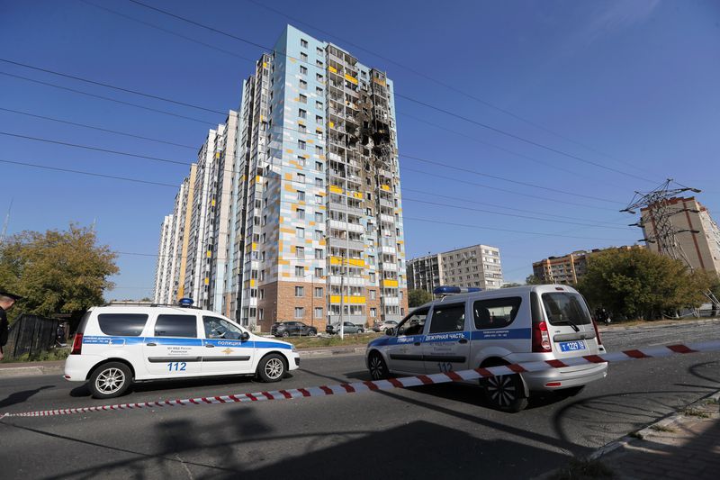 Police cars are parked at the site of the damaged multi-storey residential building following an alleged Ukrainian drone attack in Ramenskoye, outside Moscow, Moscow region, Russia, Tuesday, Sept. 10, 2024. (AP Photo)