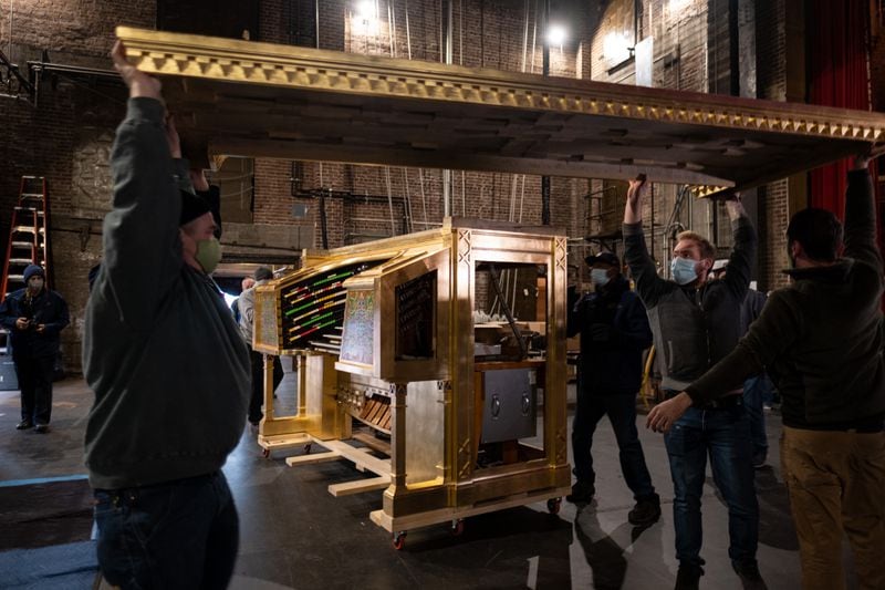 Craftsmen scraped through many layers of paint on the side panels of the Möller organ console to find the original colors of some of the organ's decorative elements. They then matched those colors with contemporary paint. Ben Gray for the Atlanta Journal-Constitution