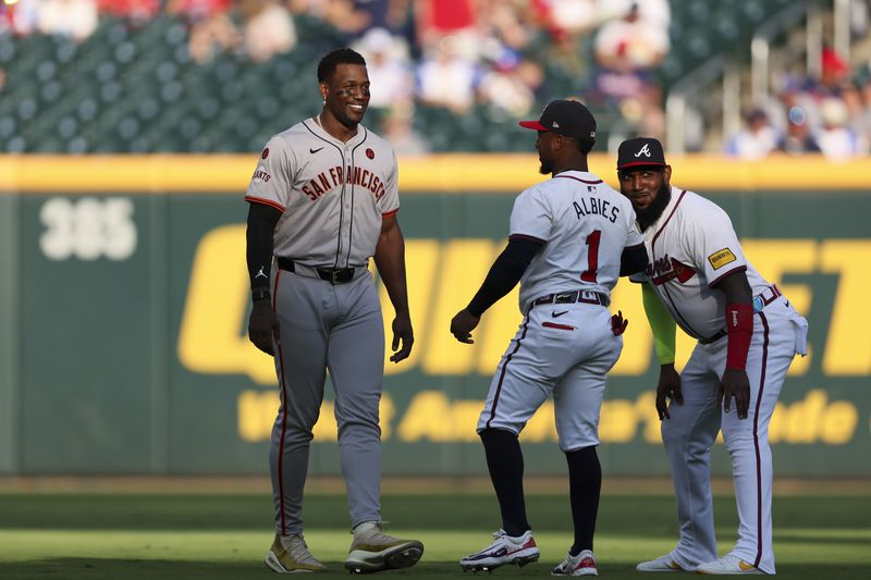 San Francisco Giants designated hitter Jorge Soler talks with Atlanta Braves second baseman Ozzie Albies (1) and designated hitter Marcell Ozuna (20) before their game at Truist Park, Tuesday, July 2, 2024, in Atlanta. (Jason Getz / AJC)
