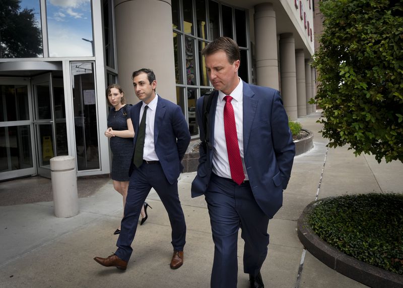 Dr. Eithan Haim, left, and his attorney, Ryan Patrick, right, leave federal court after appearing for an arraignment hearing Monday, June 17, 2024 in Houston. Haim, who calls himself a whistleblower on transgender care for minors has been indicted on federal charges of illegally obtaining private information on patients who were not under his care, with intent to cause harm to the nation's largest pediatric hospital. He has pleaded not guilty. (Yi-Chin Lee/Houston Chronicle via AP)