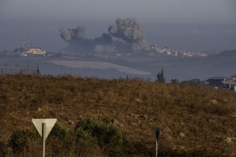 Smoke rises following Israeli bombardment in southern Lebanon as seen from northern Israel, Sunday, Oct. 6, 2024. (AP Photo/Baz Ratner)