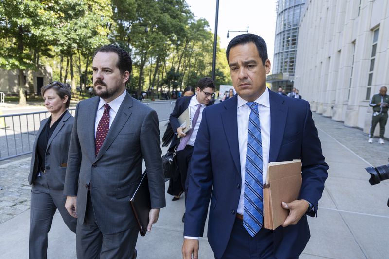 Assistant U.S. Attorney Francisco Navarro, right, leaves Brooklyn Federal court after the arraignment of longtime drug cartel leader Ismael “El Mayo” Zambada, Friday, Sept. 13, 2024, in New York. (AP Photo/Corey Sipkin)