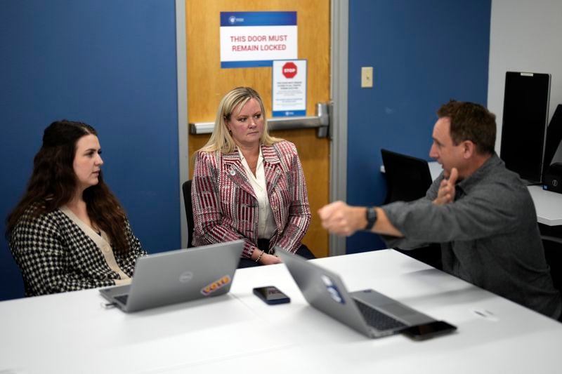 Cari-Ann Burgess, center, interim Registrar of Voters for Washoe County, Nev., speaks with Andrew McDonald, right, Deputy Registrar of Voters and Addie Vetter, elections specialist, Sept. 20, 2024, in Reno, Nev. (AP Photo/John Locher)