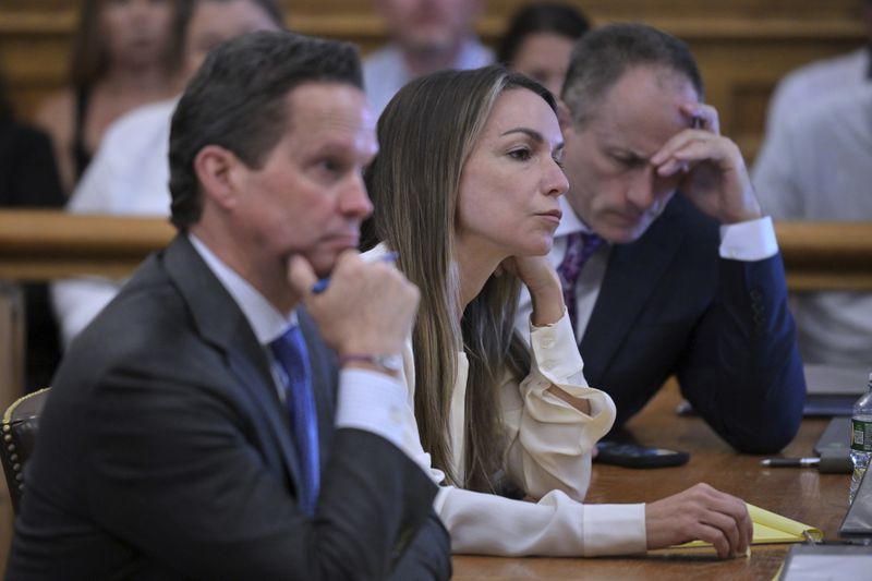 Karen Read, center, and her defense lawyers Alan Jackson, left, and David Yannetti, right, listen as the prosecution questions their witness Dr. Marie Russell, during Read's trial in Norfolk Superior Court, Friday, June 21, 2024, in Dedham, Mass. Read, 44, is accused of running into her Boston police officer boyfriend with her SUV in the middle of a nor'easter and leaving him for dead after a night of heavy drinking. (AP Photo/Josh Reynolds, Pool)