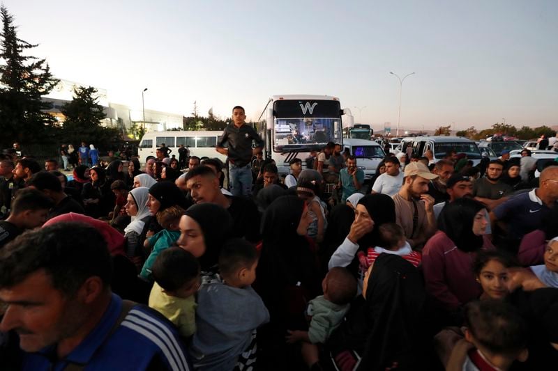 Syrians fleeing the war in Lebanon, arrive at the Syrian-Lebanese border crossing in Jdeidet Yabous, Syria, Wednesday, Sept. 25, 2024. (AP Photo/Omar Sanadiki)