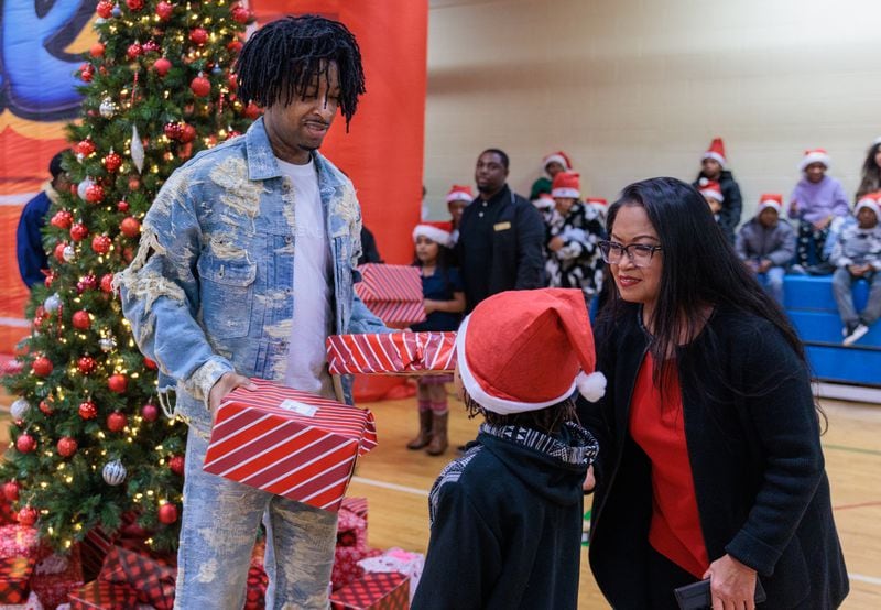 Rapper 21 Savage gives out gifts to children at the Wade Walker Park Family YMCA in Stone Mountain on Wednesday, December 21, 2022 as part of his Leading By Example Foundation. Dec. 21 was pronounced “21 Savage Day” in the state for the rapper’s philanthropic efforts. (Arvin Temkar / arvin.temkar@ajc.com)