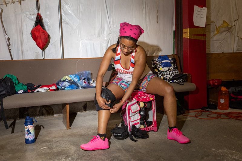 Camille Watwood, aka Susie Scarmichael, gets ready for practice at the Atlanta Roller Derby practice facility in Mableton on Wednesday, May 22, 2024. (Arvin Temkar / AJC)