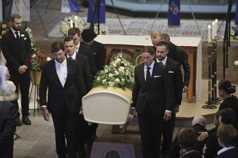 The coffin of Swedish soccer manager Sven-Goran Eriksson is carried out of the Fryksände church after the funeral service in Torsby, Sweden, Friday Sept. 13, 2024. (Adam Ihse/TT News Agency via AP)