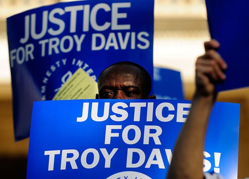 Bliss Piaro, 49, from Byron, Ga., joins protesters he says, "for justice" at the Georgia State Capitol in a rally against the planned execution of Troy Davis.