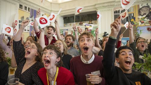 People cheer at the first exit poll at the Socialist People's Party for the election to the European Parliament at Christiansborg in Copenhagen, Sunday, June 9, 2024. (Bo Amstrup/Ritzau Scanpix via AP)