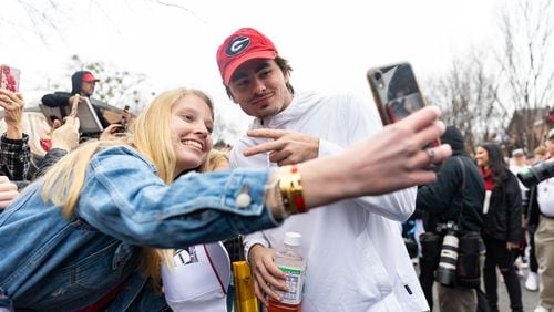 University of Georgia football player JT Daniels interacts with fans during the Dawg Walk as part of the team’s celebration parade in Athens, Georgia on January 15th, 2022.(Nathan Posner for The Atlanta Journal-Constitution)