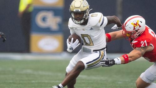 Georgia Tech wide receiver Christian Leary (0) runs afte r a catch as Virginia Military Institute linebacker Camden Clinton (21) defends during the first half of a NCAA college football game Saturday, Sept. 14, 2024, in Atlanta,. (AP Photo/John Bazemore)