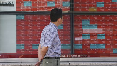 FILE - A person looks at an electronic stock board showing Japan's stock prices, at a securities firm Thursday, Sept. 26, 2024, in Tokyo. (AP Photo/Eugene Hoshiko, File)