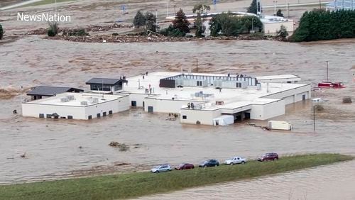 In this image made from a video provided by NewsNation, people can be seen on the roof of the Unicoi County Hospital in Erwin, Tenn., on Friday, Sept. 27, 2024. (NewsNation via AP)